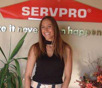 White female in front of SERVPRO sign